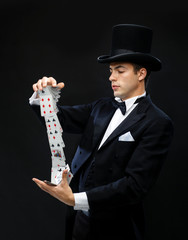 magician showing trick with playing cards