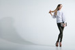 © julenochek - Fashionable woman with a bag in light background