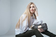 © julenochek - Fashionable woman with a bag in light background