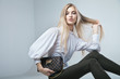 © julenochek - Fashionable woman with a bag in light background