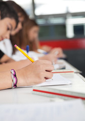 High School Students Writing At Desk