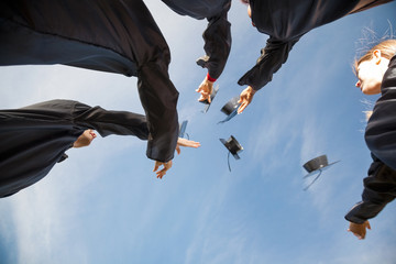 Students Throwing Mortar Boards In Air On Graduation Day