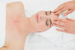 © lightwavemedia - Hands massaging a beautiful woman's forehead at beauty spa