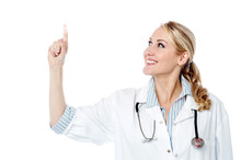 Smiling Female Doctor Pointing Upwards