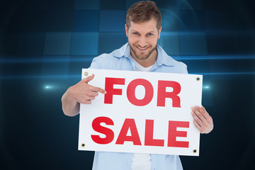 Poster - Composite image of smiling model holding a for sale sign
