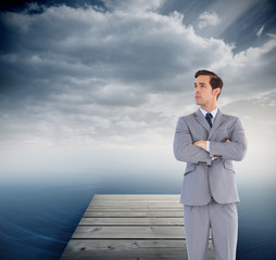 Poster - Composite image of serious businessman with arms crossed