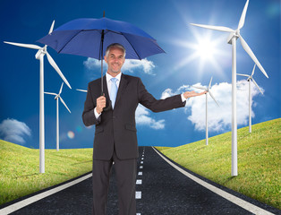 Poster - Composite image of peaceful businessman holding blue umbrella
