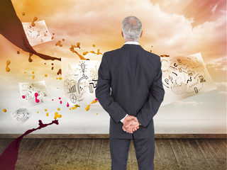 Poster - Composite image of rear view of serious businessman posing
