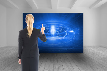 Wall Mural - Composite image of businesswoman pointing somewhere