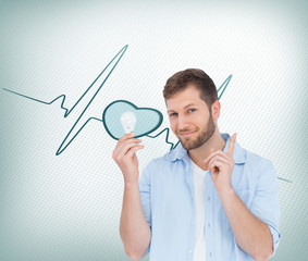 Poster - Composite image of charming model holding a bulb in right hand