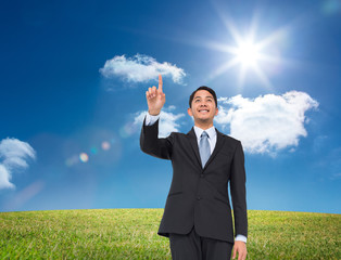 Poster - Composite image of smiling asian businessman pointing