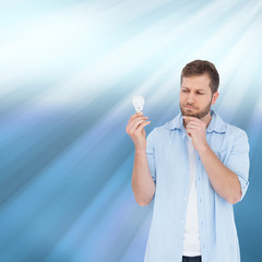 Poster - Composite image of sceptical model holding a bulb