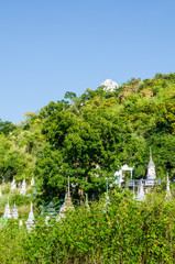 Thai style stupa with green mountain