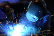 canvas print picture - worker while doing a welding with arc welder