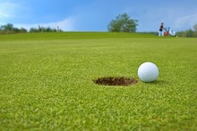 Golf, Ball Lying On The Green Next To Hole