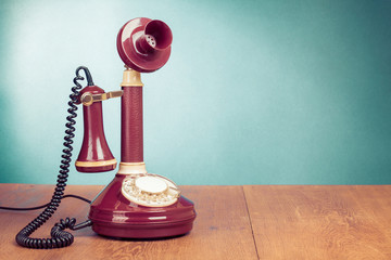Fototapete - Vintage old telephone on wood table near aquamarine wall