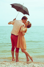 Summer Vacation Concept. Couple Standing On Beach And Kissing
