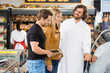© Tyler Olson - Worker Assisting Couple At Butcher's Shop