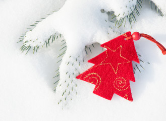 red christmas tree toy in snow