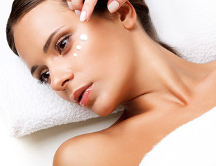 Wall Mural - Close-up of a Young Woman Getting Spa Treatment. Cosmetic Cream