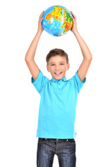 Fototapete - Smiling boy in casual  holding globe in hands above his head