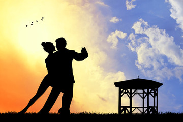 Wall Mural - couple dancing silhouette at sunset