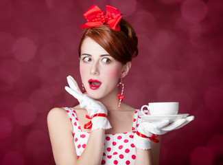 Beautiful redhead women with cup of tea.