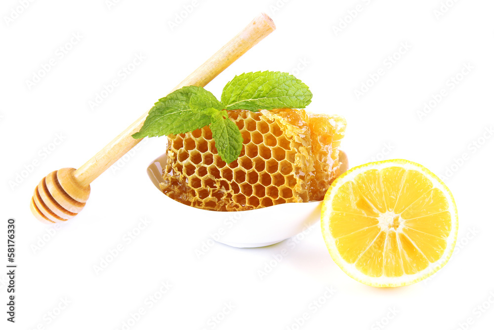 Sweet honeycombs in bowl isolated on white