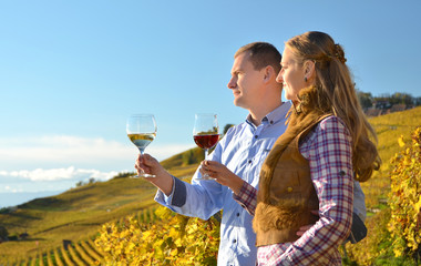 Wall Mural - Man and woman tasting wine among vineyards in Lavaux, Switzerlan