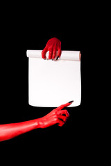 Wall Mural - Red devil hands with black nails holding paper scroll