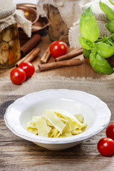 Sticker - Bowl of macaroni on wooden table. Fresh vegetables