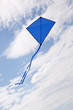 blue kite flying in a beautiful sky clouds