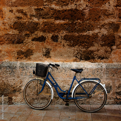 Obraz w ramie Bicycle in historical Ciutadella stone wall at Balearics