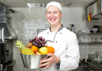 Wall Mural - chef preparing food in the kitchen at the restaurant