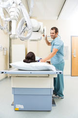 Wall Mural - Nurse Adjusting Xray Machine For Patient