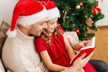 Canvas Print - smiling father and daughter reading book