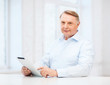 © Syda Productions - old man with tablet computer at home