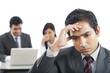 © imagedb.com - Close-up of a businessman looking upset with his colleagues in the background