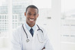 © lightwavemedia - Confident smiling male doctor in a medical office