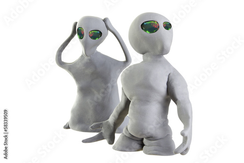 gray alien made of clay on a white background плакат