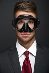 Wall Mural - Businessman on a black background smiling wearing a snorkel and