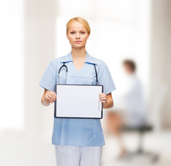 Poster - smiling female doctor or nurse with sclipboard