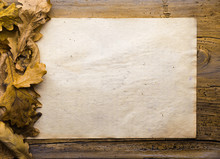 Leaves And Paper On Wooden Background