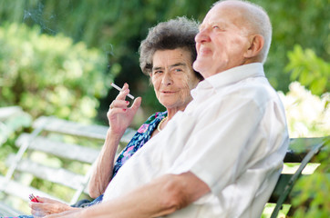 Wall Mural - Senior man and woman smoking