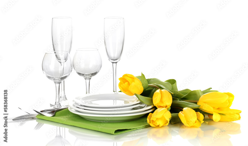 Yellow tulips and utensils for serving isolated on white