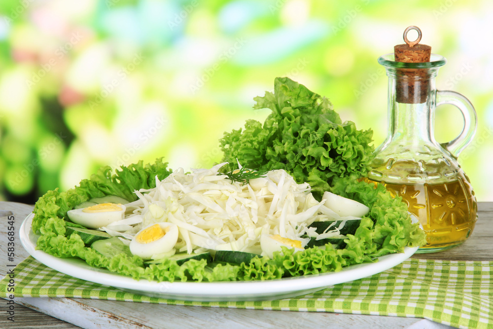 Delicious salad with eggs, cabbage and cucumbers on wooden
