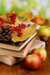 Fototapete - Books and autumn leaves on wooden table on natural background
