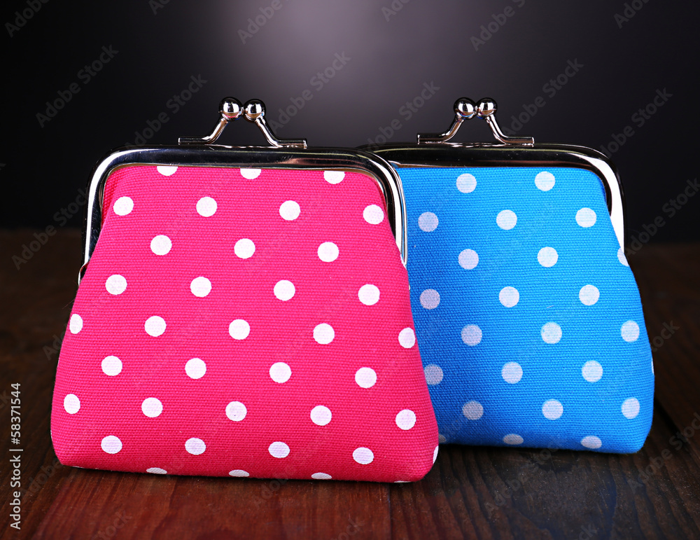Blue and pink purses on table on black background
