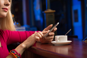 close-up of female hands holding a cell phone