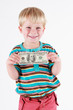 © mrshining - Smiling boy holding a bank note in his hands